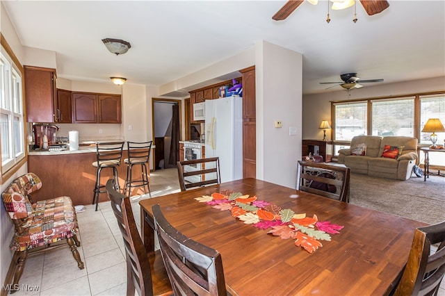 dining area featuring light tile patterned floors and ceiling fan