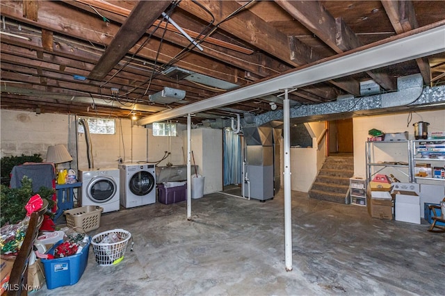 basement with heating unit and washing machine and clothes dryer