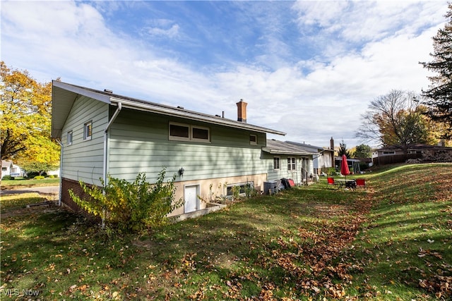 view of home's exterior with a lawn