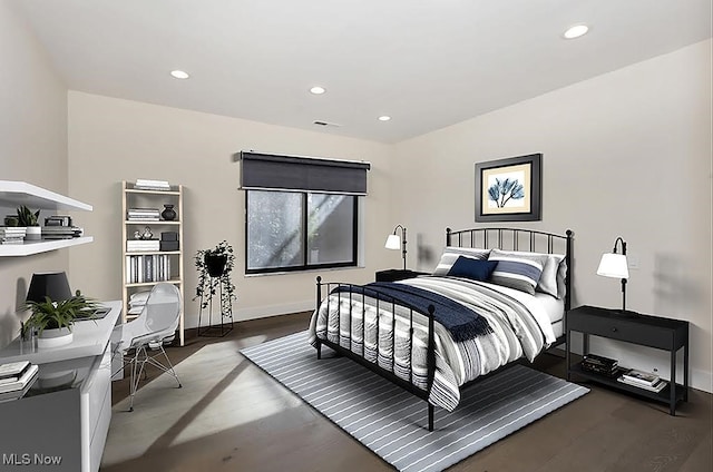 bedroom with dark wood-type flooring