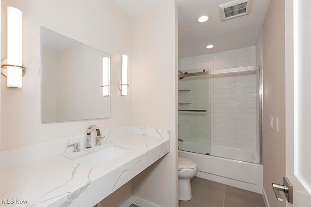 full bathroom with vanity, toilet, tile patterned floors, and enclosed tub / shower combo