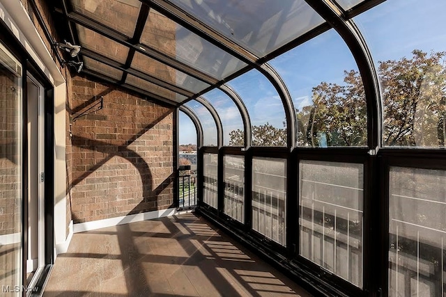 unfurnished sunroom with lofted ceiling