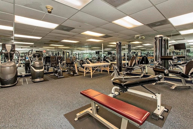 workout area with a drop ceiling and carpet floors