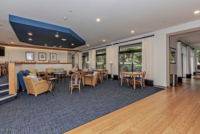 dining area featuring hardwood / wood-style floors and a raised ceiling