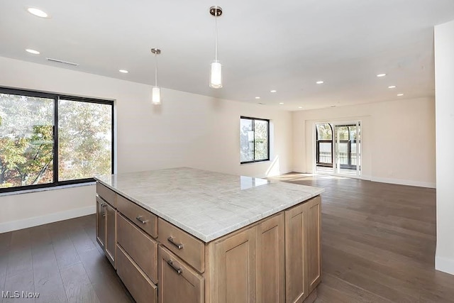 kitchen featuring dark wood-type flooring, a center island, and hanging light fixtures