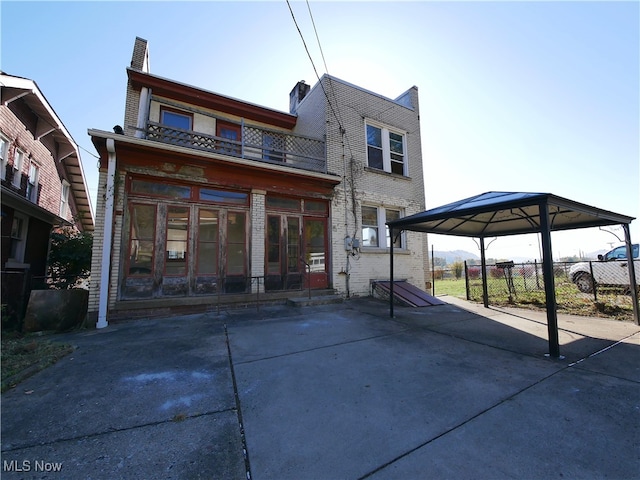 back of house featuring a balcony and a gazebo