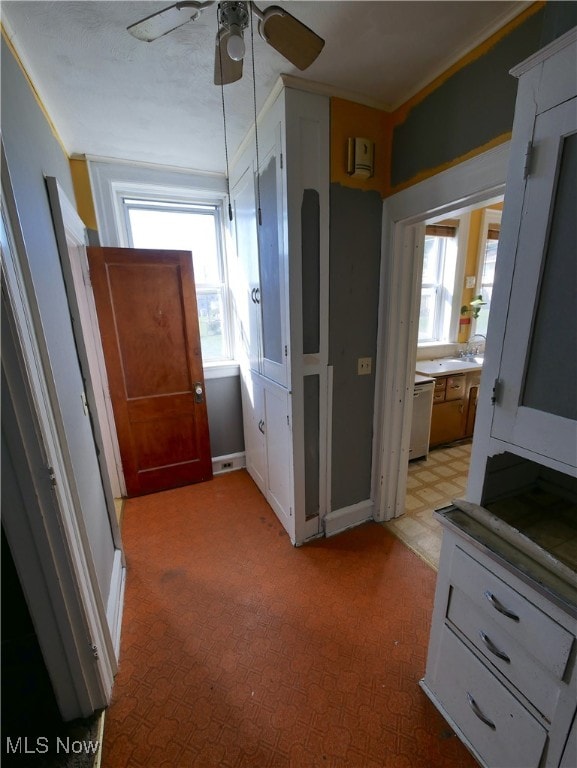 hallway featuring ornamental molding