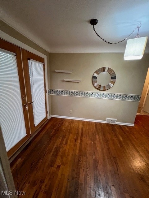 unfurnished dining area with french doors and dark hardwood / wood-style flooring