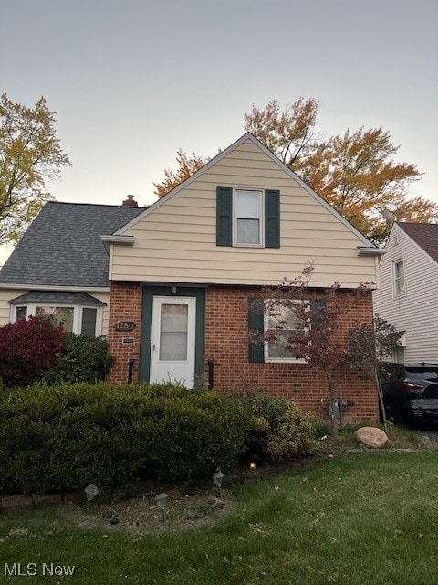 bungalow-style home with a lawn