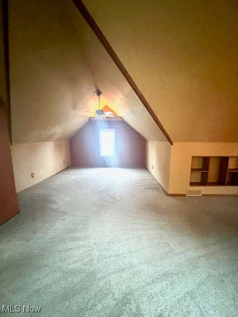 bonus room with ceiling fan, carpet, and lofted ceiling