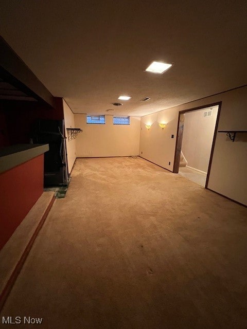 basement featuring light colored carpet