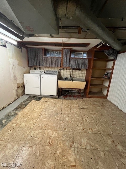 basement with sink and washing machine and clothes dryer