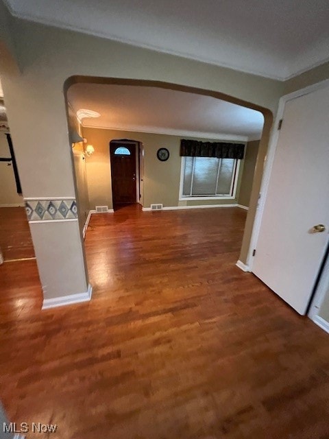 hall featuring ornamental molding and hardwood / wood-style floors