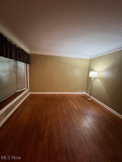 spare room with ornamental molding and hardwood / wood-style floors