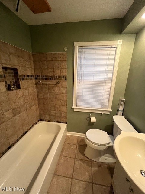 bathroom with toilet, tile patterned floors, and sink