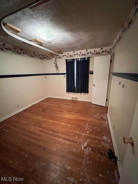 unfurnished room with hardwood / wood-style floors