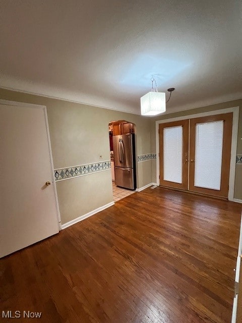 unfurnished room with light hardwood / wood-style floors and french doors