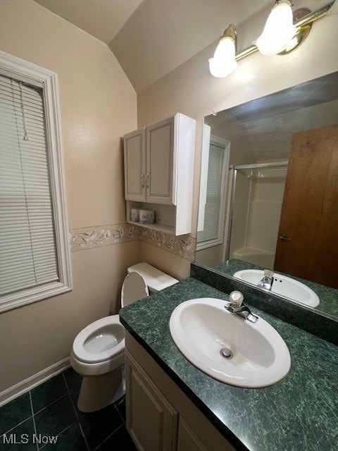 bathroom with a shower with door, toilet, tile patterned flooring, vaulted ceiling, and vanity