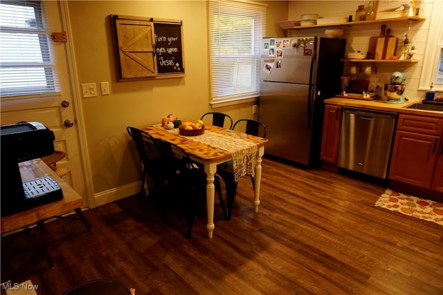 dining area with sink and dark hardwood / wood-style floors