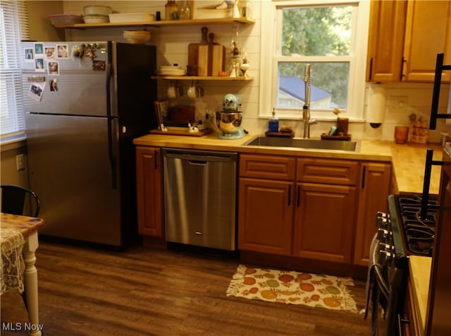 kitchen featuring sink, dark wood-type flooring, and stainless steel appliances