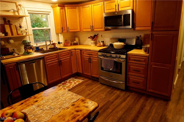 kitchen with decorative backsplash, stainless steel appliances, sink, and dark hardwood / wood-style flooring