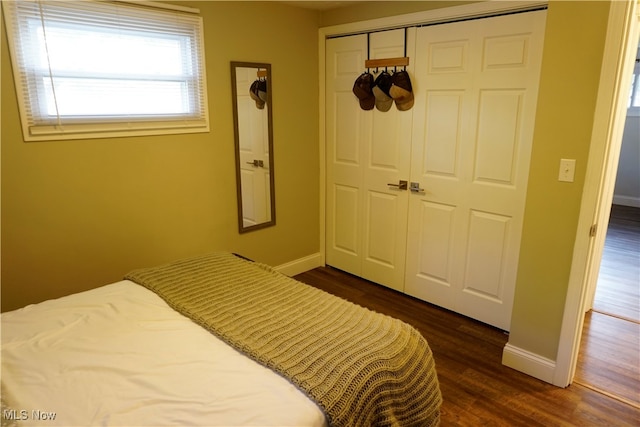 bedroom with a closet and dark hardwood / wood-style flooring