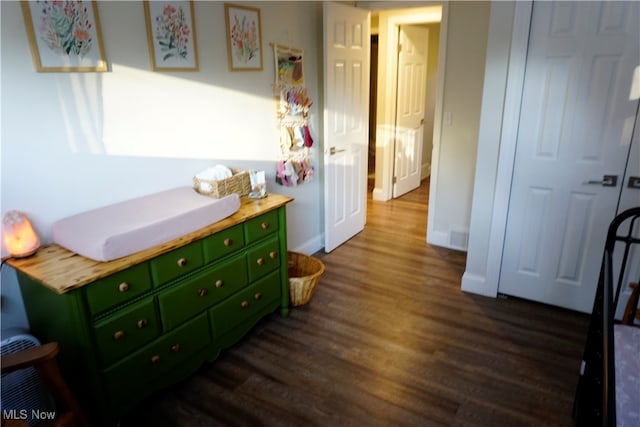 bedroom featuring a closet and dark wood-type flooring