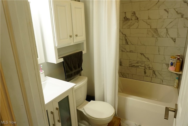 full bathroom featuring vanity, shower / tub combo with curtain, and toilet