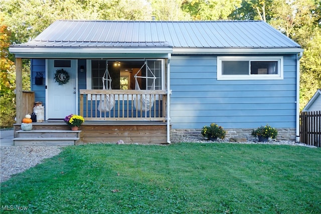 view of front of house with a porch and a front lawn