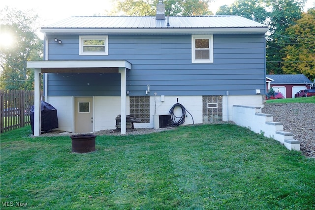 rear view of house with a lawn