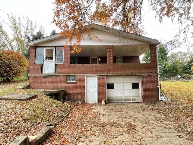 rear view of house with a garage