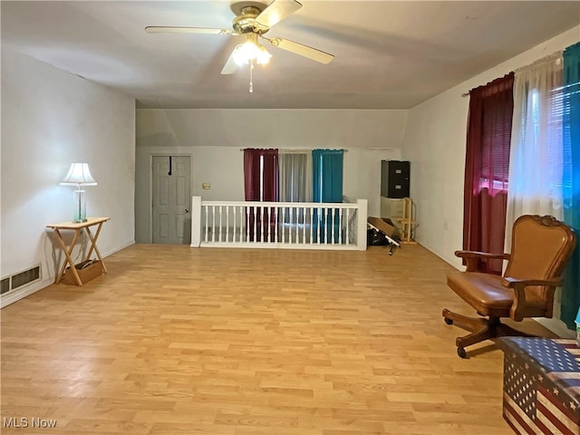 living area featuring ceiling fan, vaulted ceiling, and light hardwood / wood-style flooring