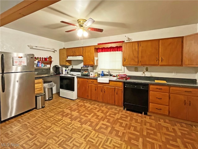 kitchen with sink, stainless steel appliances, light parquet flooring, and ceiling fan