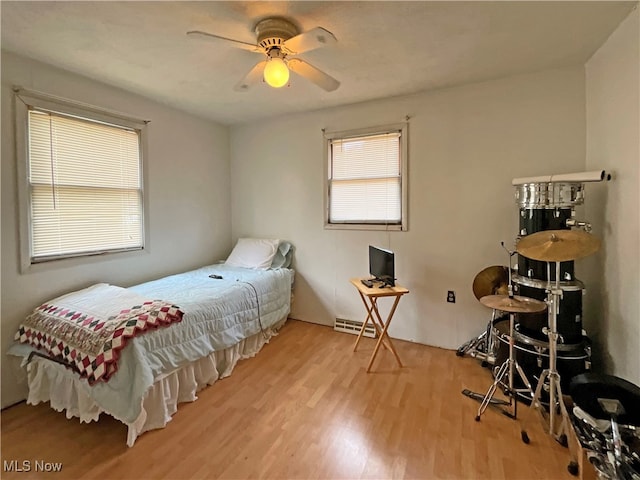 bedroom with light wood-type flooring and ceiling fan