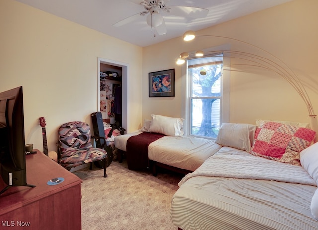 bedroom with a closet, light carpet, and ceiling fan