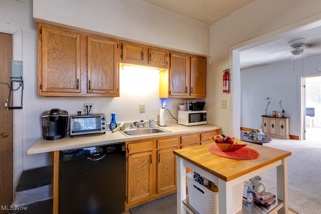 kitchen with black dishwasher, sink, carpet floors, and ceiling fan