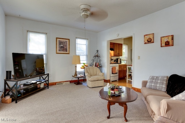 living room with light colored carpet and ceiling fan