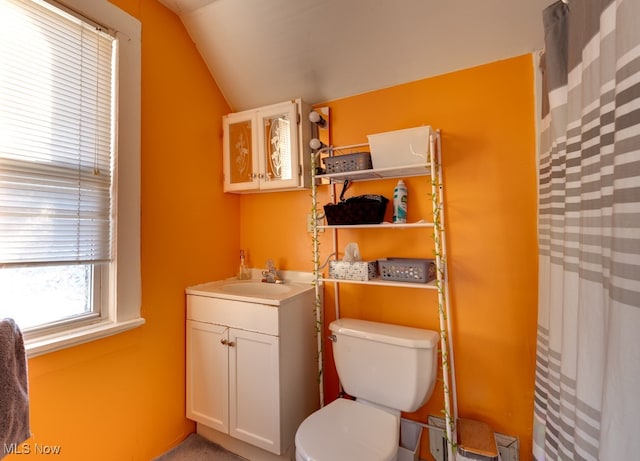 bathroom with toilet, lofted ceiling, a shower with curtain, and vanity