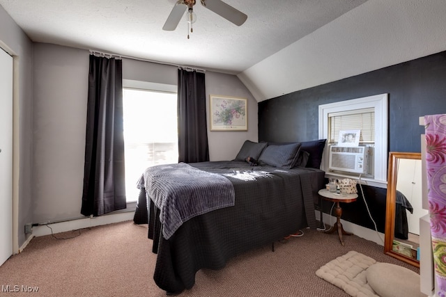 carpeted bedroom with cooling unit, a textured ceiling, vaulted ceiling, and ceiling fan