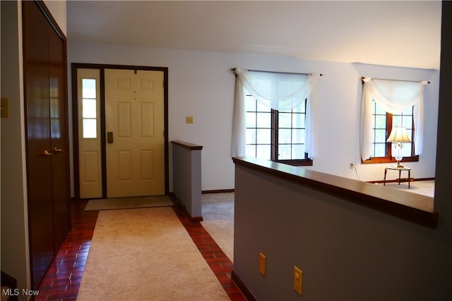 foyer with dark colored carpet