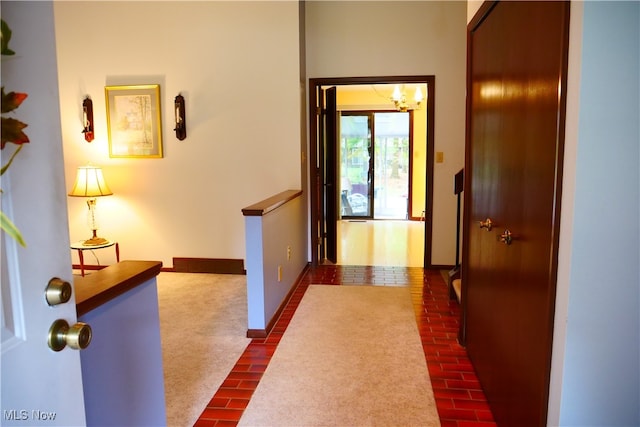 hall with dark colored carpet