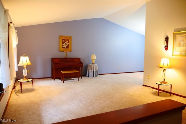 sitting room featuring carpet flooring and lofted ceiling