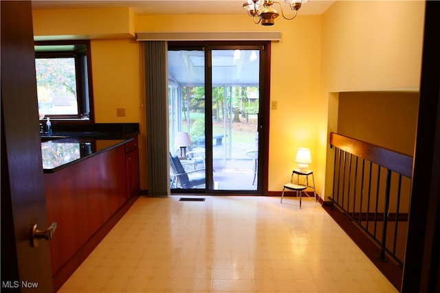 entryway featuring a notable chandelier