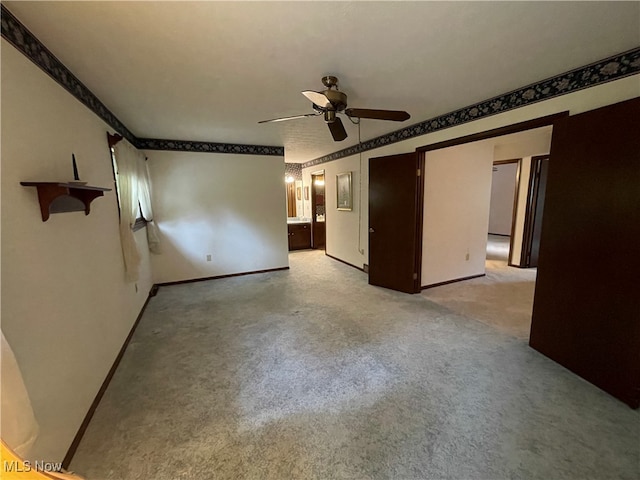 spare room with ceiling fan and light colored carpet