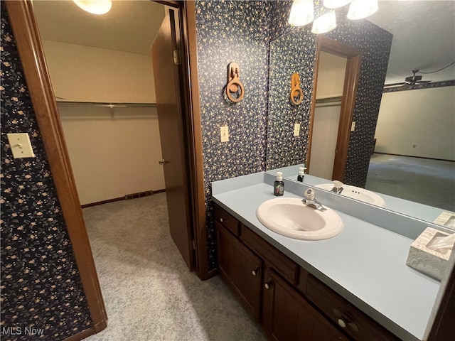 bathroom featuring vanity, a textured ceiling, and ceiling fan