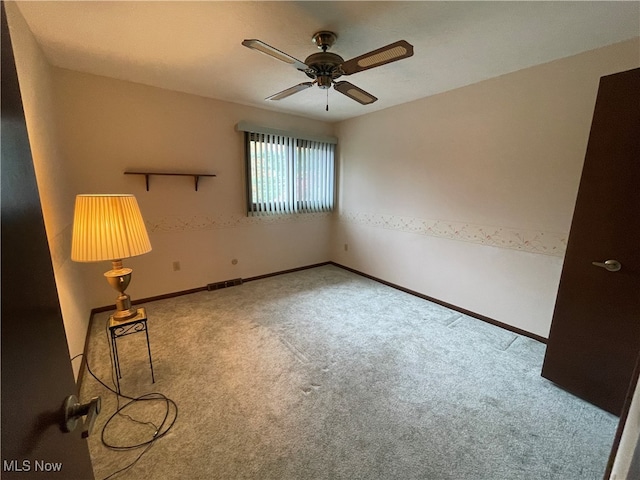 empty room with carpet floors and ceiling fan