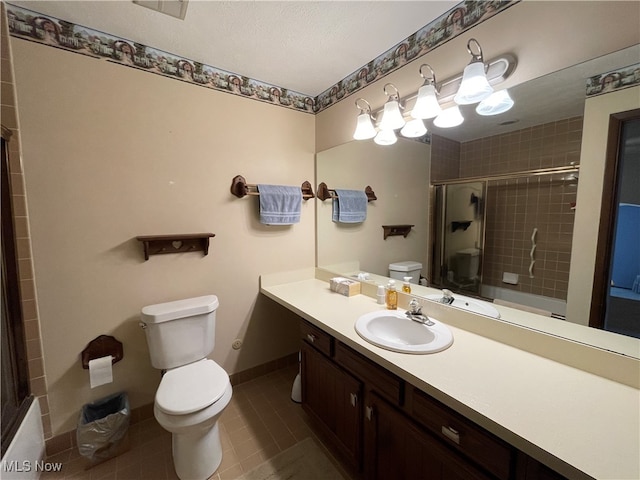 bathroom featuring vanity, toilet, a shower with shower door, and tile patterned flooring