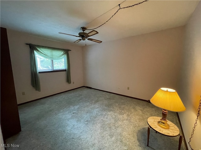 carpeted empty room with ceiling fan