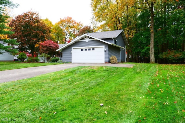 view of front of home featuring a garage and a front lawn