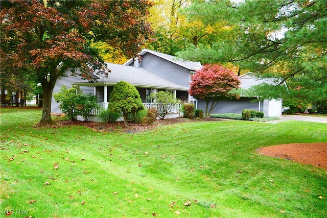 view of front of property with a front yard and covered porch